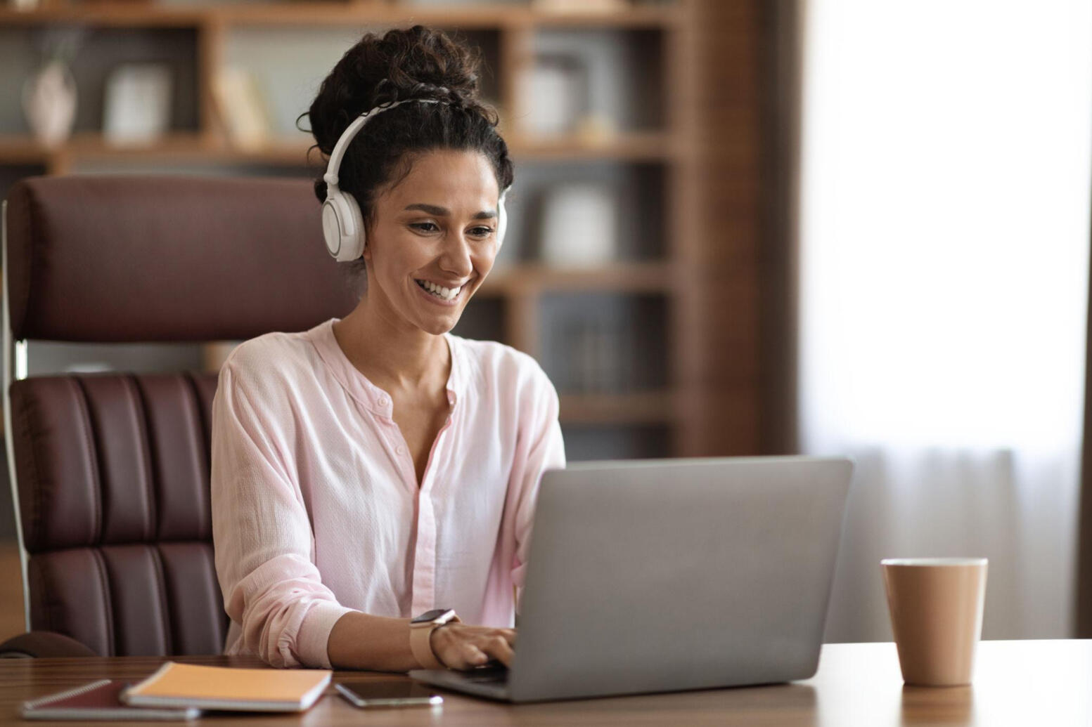 A candidate on a laptop/video interview, looking comfortable and professional.